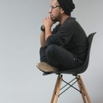 Man sitting in a chair deep in thought, representing maintaining independent thinking while using AI tools