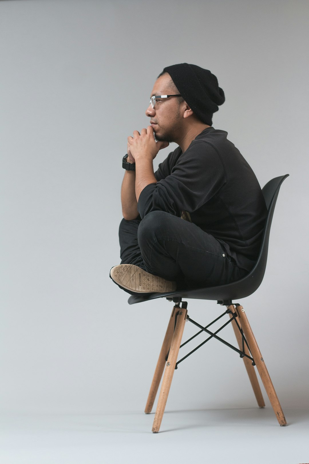 Man sitting in a chair deep in thought, representing maintaining independent thinking while using AI tools