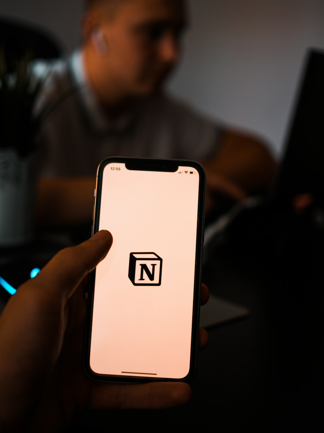 Person holding a cell phone, representing using an AI study app on the go