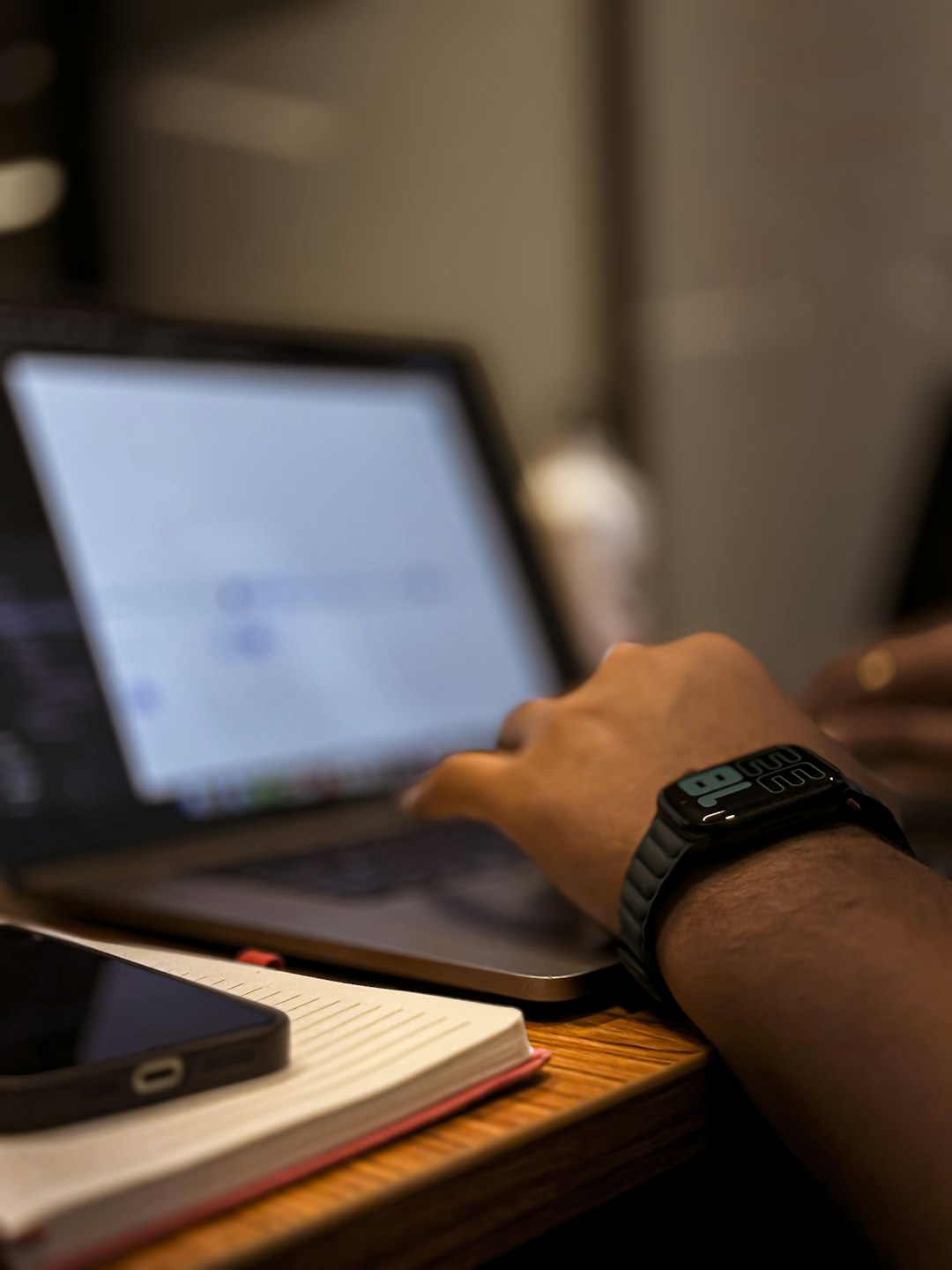 Person using a laptop on a desk, representing someone learning to code