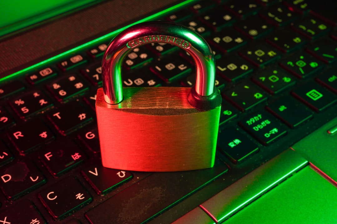 Red padlock resting on a black computer keyboard, representing password and account security