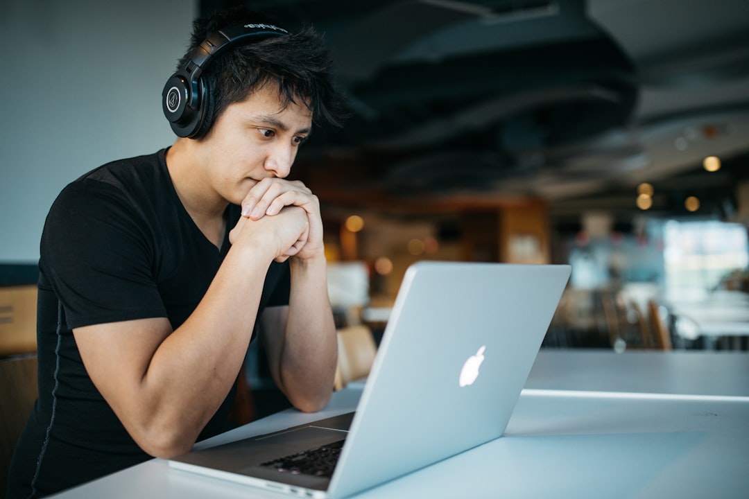 Student wearing headphones studying at a laptop, representing AI-assisted learning